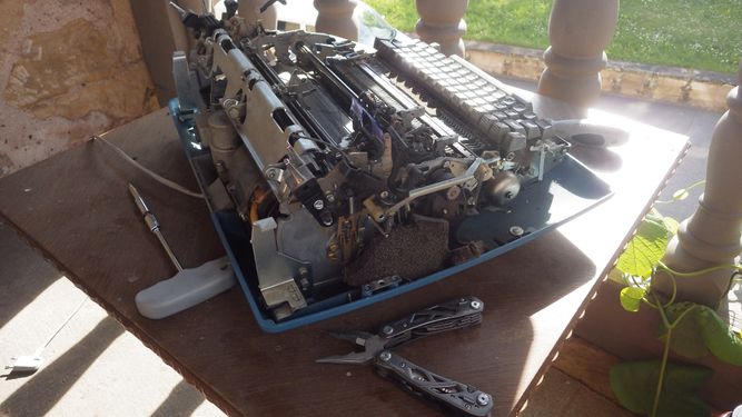 broken electric typewriter (IBM, 1970's) with the main chassis detached